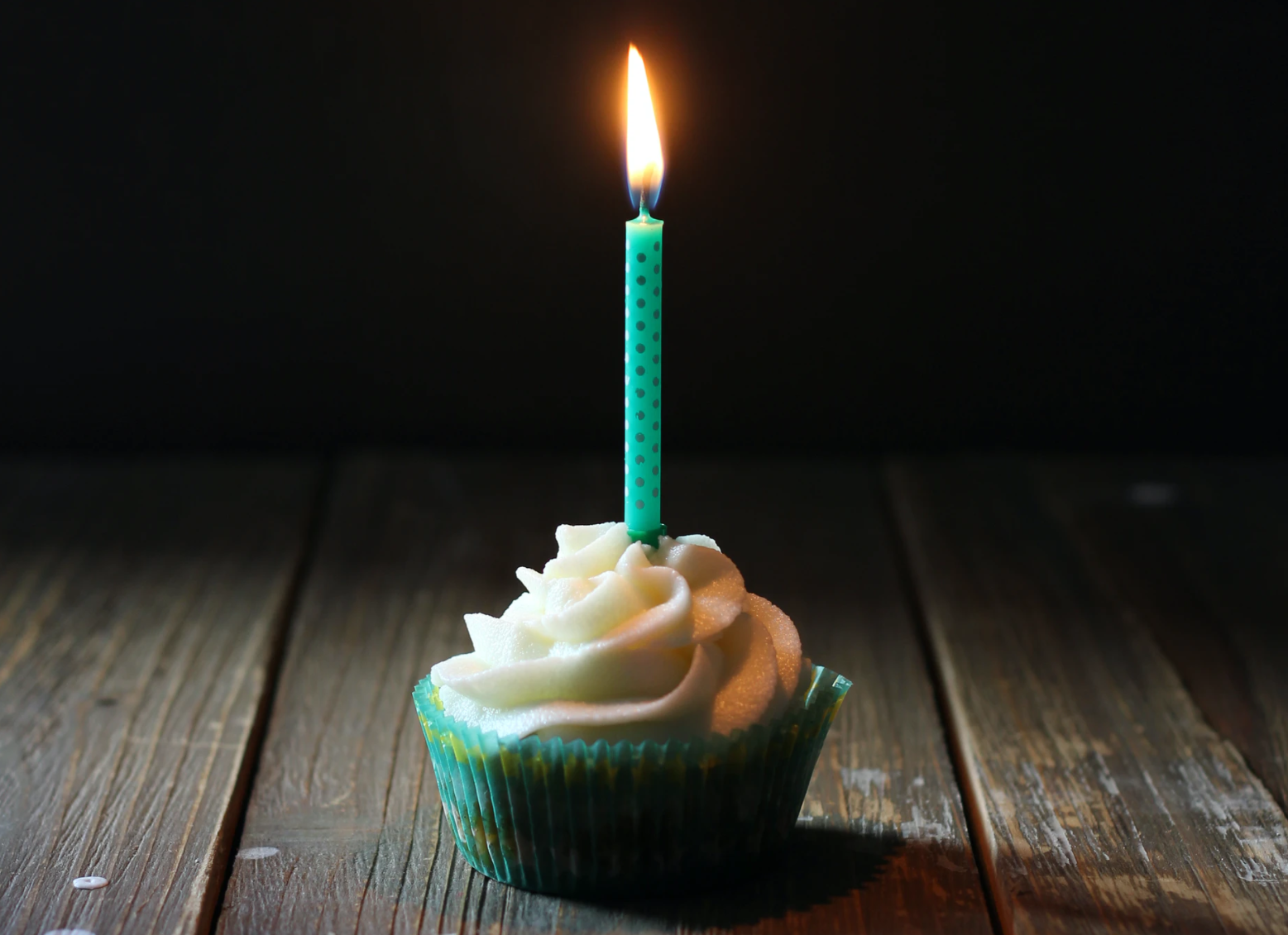 Cumpleaños define la profesión. Cupcake con vela de cumpleaños encendida.